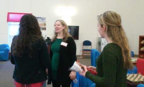 Carter talking to students in the library. 