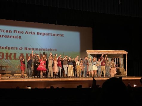 Oklahoma! cast bowing to the audience at the end of their performance