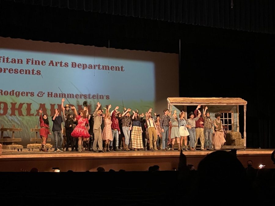 Oklahoma! cast bowing to the audience at the end of their performance