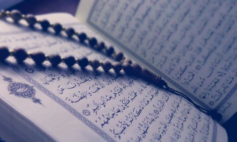 A picture of a tasbeeh (set of beads) on top of a Quran