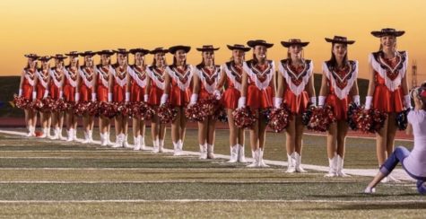 The sweethearts standing in line formation on the football field