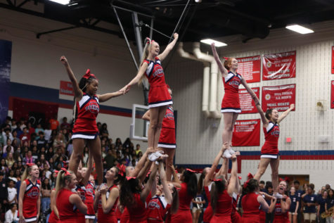 Cheerleaders performing a stunt at the Centennial High School pep rally