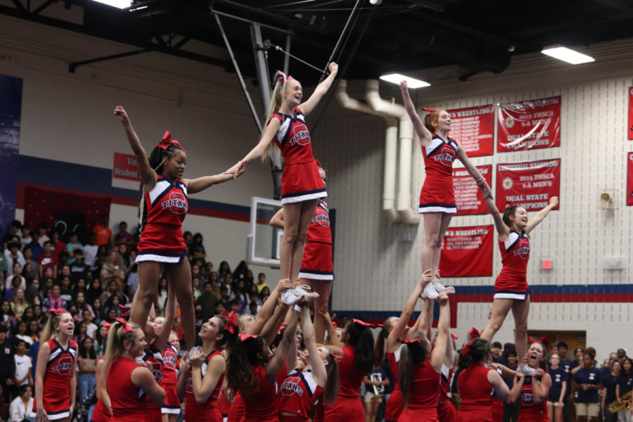 Cheerleaders+performing+a+stunt+at+the+Centennial+High+School+pep+rally