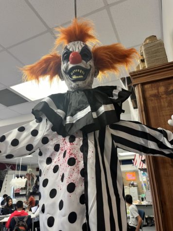 Image of a life size clown hanging from the ceiling