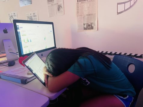 Student Aslyn Quijano doing homework and napping off the stress