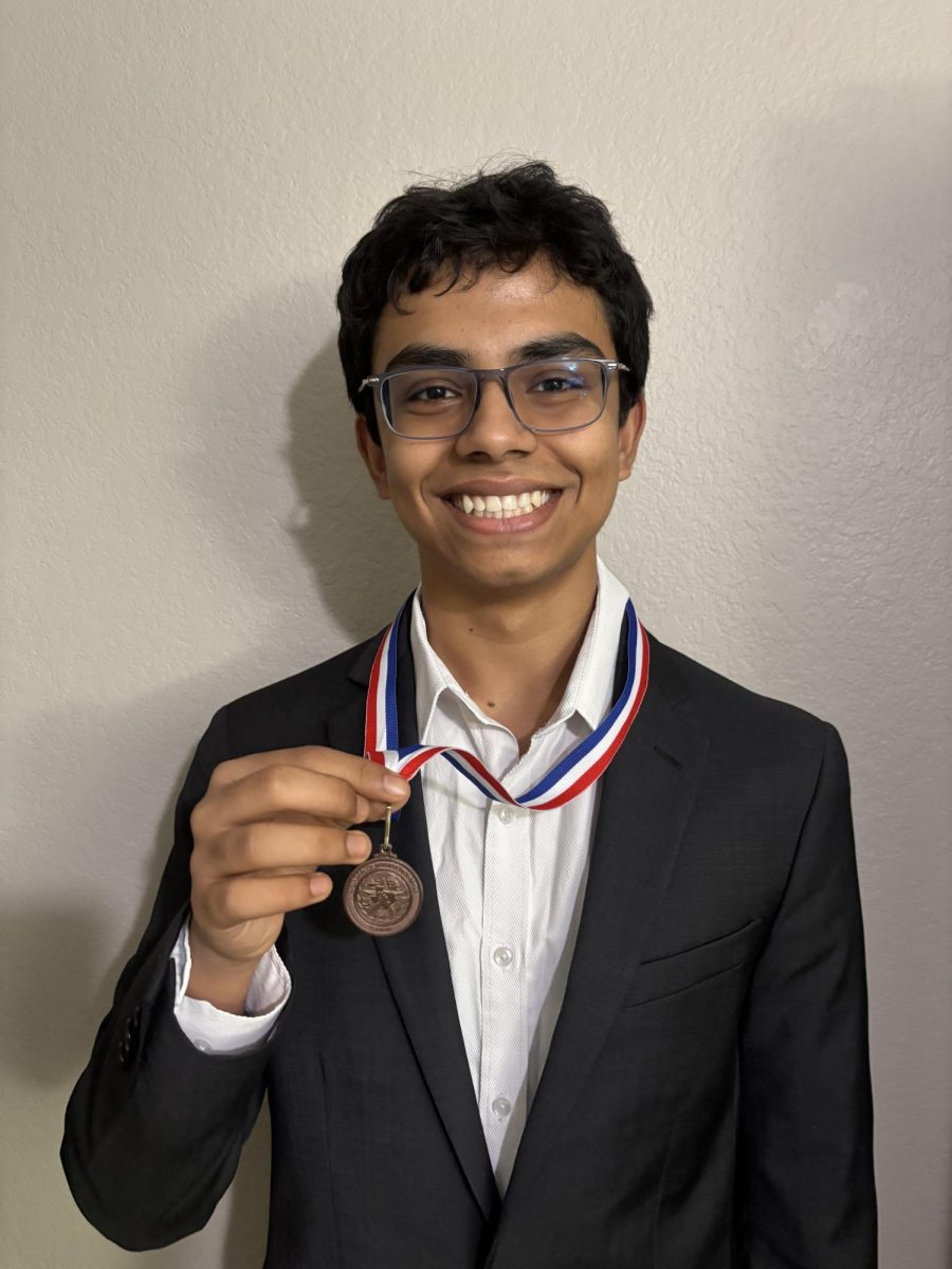 Aryan Bhattacharya with the medal he earned in the UIL Mock Congress competition