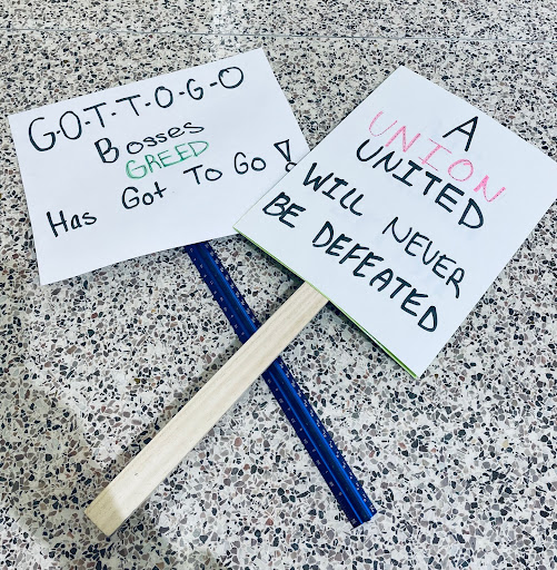 Two examples of protestor signs featuring two different chants used on the picket line.