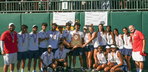 The tennis team posing after the awesome win.