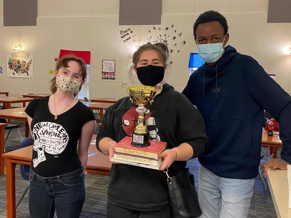 Members of 2021's Battle of the Book's Centennial team with their trophy