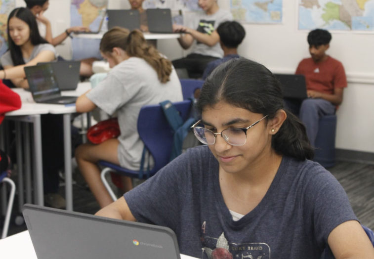 AP Human Geography class working in their Chromebooks, Prajna Bendalam in focus.