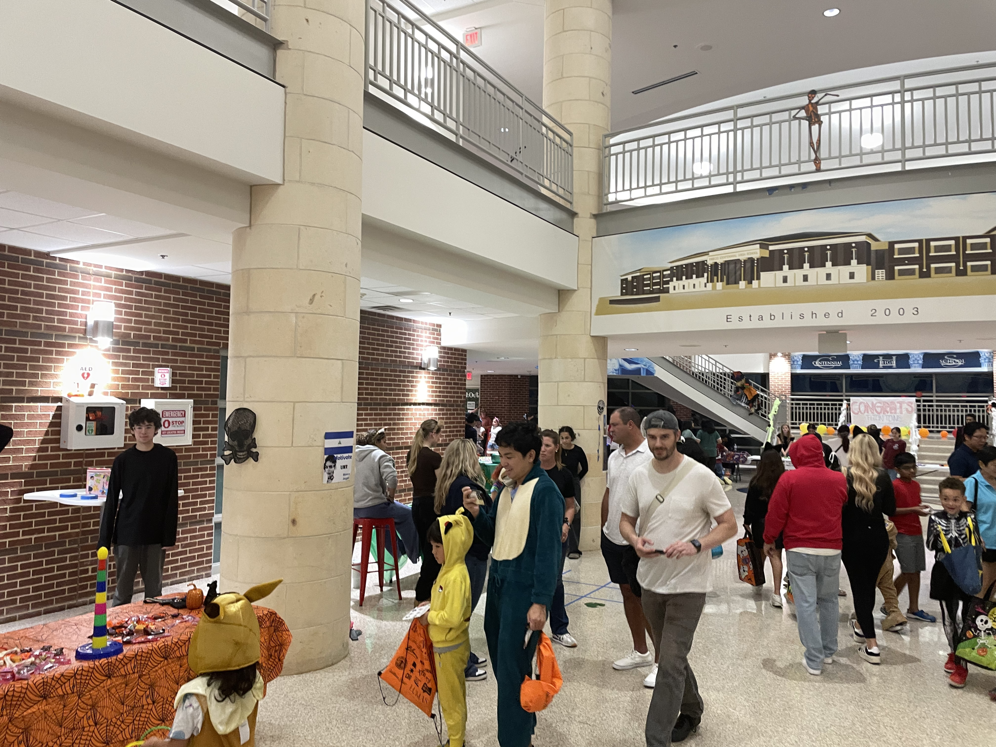 A image inside the front of the school, showing multiple families getting candy